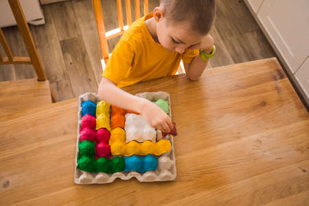Colorful puzzle made of multi-colored egg trayの写真素材