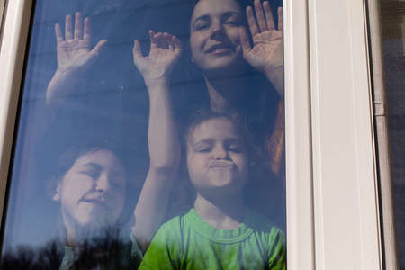 Mom and her daughters enjoy the spring weather indoorの写真素材