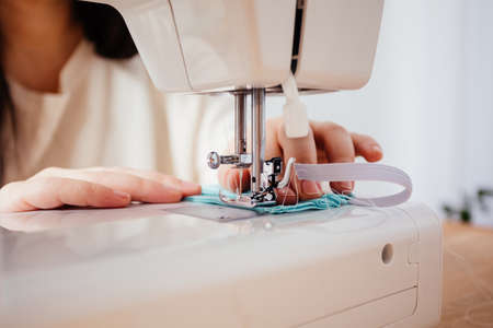 Professional dressmaker sewing protective medical mask, closeup viewの写真素材
