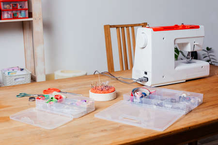 Modern sewing machine with variety of threads in boxの写真素材