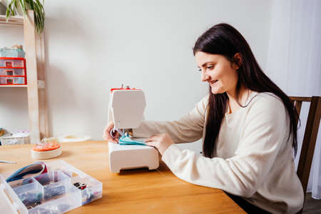 Handmade medical mask on white modern sewing machine