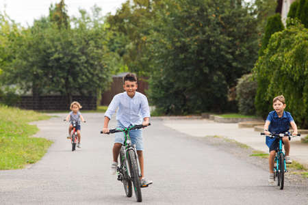 Kids have a leisure on bicycles outoodrsの写真素材
