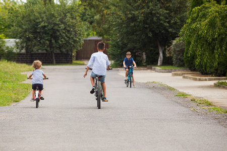Kids have a leisure on bicycles outoodrs