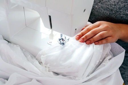 Wedding dressmaker altering white vintage wedding dressの写真素材