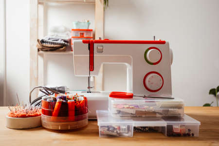 Modern sewing machine with variety of threads in box