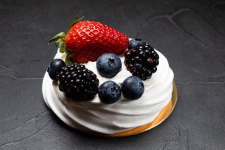 The Pavlov dessert with white cream and fruitsの写真素材