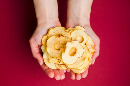 Top view handful of round dried slices of appleの写真素材
