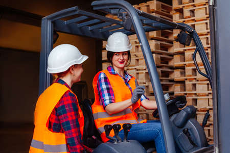 Young female warehouse workers solving working issuesの写真素材
