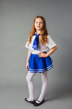 The little girl is posing in a sailor costumeの写真素材