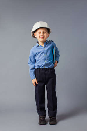 The little boy with tablet dressed in a costume of engineerの写真素材