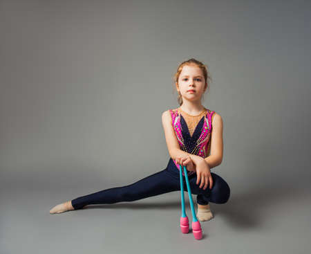 The little girl gymnast is posing with instrumentsの写真素材
