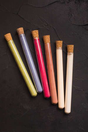 Plant based powders in glass tubes on black