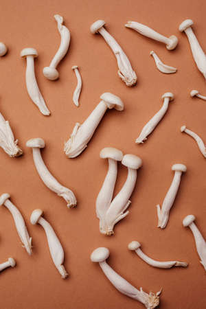 Shimeji mushroom or White beech mushrooms on brown background.
