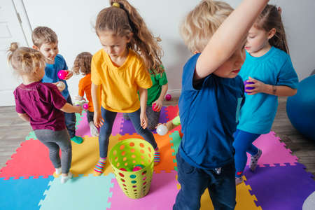 Sporty kids enjoying activities with young teacherの写真素材