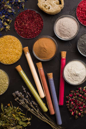 Natural handmade cosmetics ingredients on dark background
