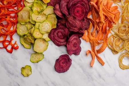 Dehydrated vegetables heap isolated on white as a snack for vegetariansの写真素材