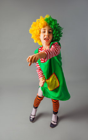 The little girl in a clown uniform has funの写真素材