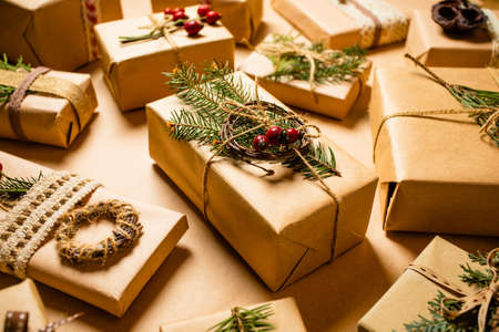 Woman decorates Christmas gifts with eco-friendly materialsの写真素材