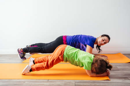 Happy mother likes to do sport together with her sonの写真素材