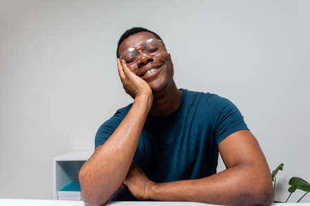 Lonely man carefully listening to online conference speakerの写真素材