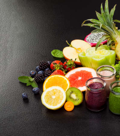 Group of different fruit smoothies in glasses various vegetables and fruits