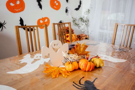 Wooden dining table decorated for Halloween partyの写真素材