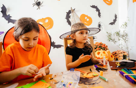 Girls doing autumn handicraft during creative workshopの写真素材