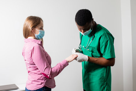 Doctor providing health check for patient after pandemicの写真素材