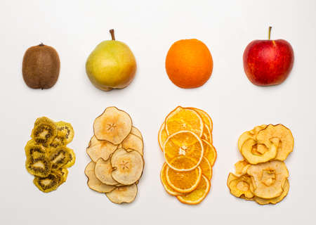 The dry pieces of different fruits in a row to fresh fruitsの写真素材