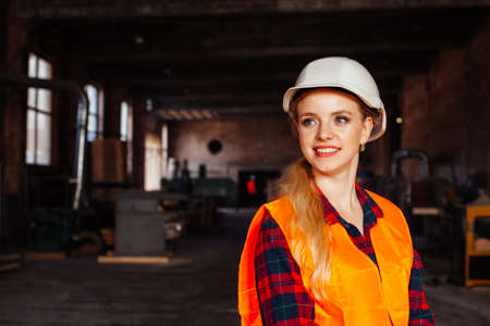 Joyful woman looks at the camera in the factoryの写真素材