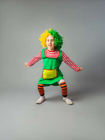 The little girl jumps in a clown uniformの写真素材