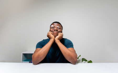 Lonely man carefully listening to online conference speakerの写真素材