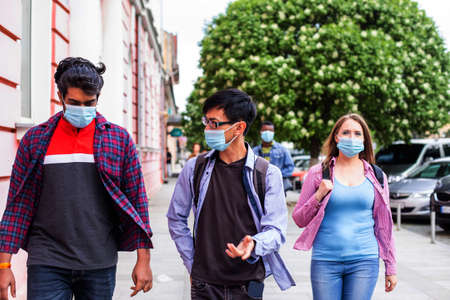 People in medical masks walking on streetの写真素材