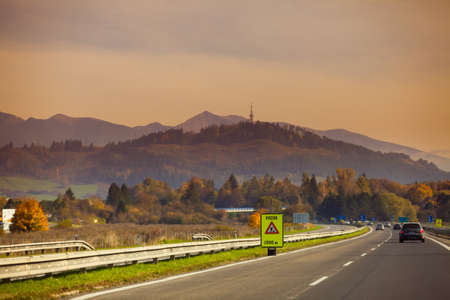 Car on the road in the evening sunset