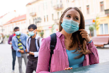 Shopping while lockdown. Woman waiting to pick up order from the delivery officeの写真素材