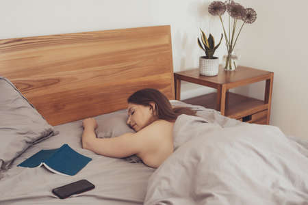 Woman felt asleep while long reading in bed