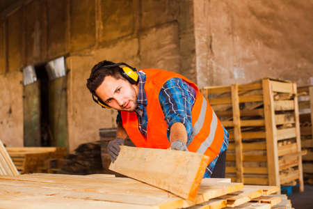 The young worker in uniform works at the warehouseの写真素材