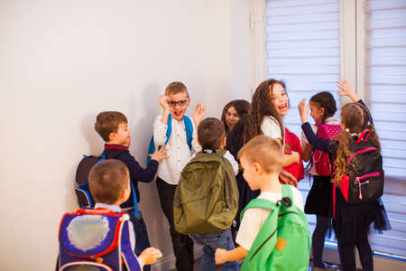 Happy school kids are ready for education. School children in uniform with backpacks going to classの写真素材