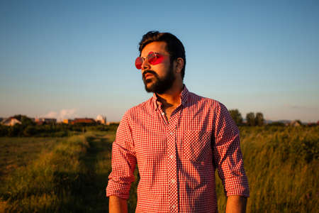 Man in pink glasses enjoying sunny weatherの写真素材