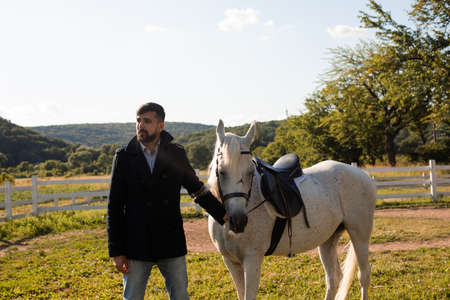 Man with a horse on a background of beautiful natureの写真素材