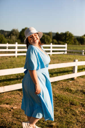 Candid woman in hat at farmland enjoy the summerの写真素材