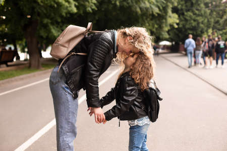 Mom and daughter having fun while walking around the cityの写真素材