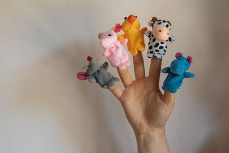 Woman hand wearing five finger puppets close upの写真素材