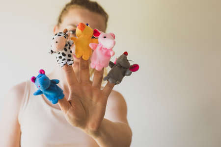 Woman hand wearing five finger puppets close upの写真素材