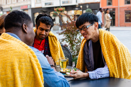 Multiracial group of friends having a drink togetherの写真素材