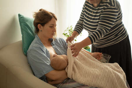 Breastfeeding consultant supports young mother to overcome problemsの写真素材