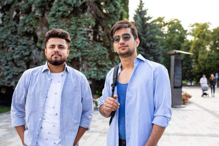 Two indian student with backback stand at the street.の写真素材