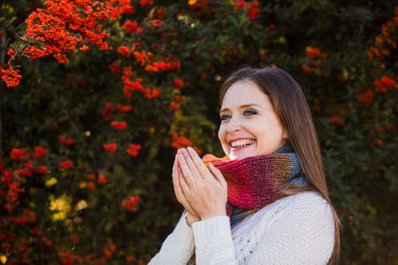 Woman portrait on fall nature background in a dayの写真素材