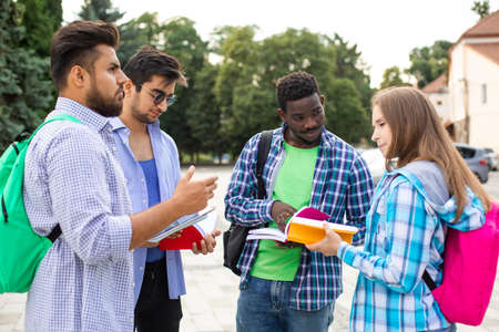 The multinational students talk to each other about booksの写真素材