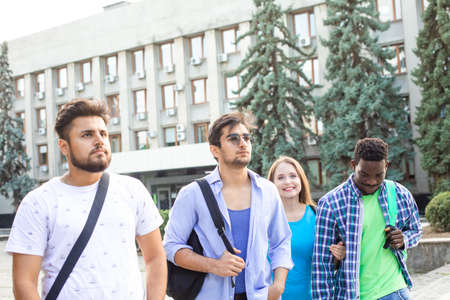 The diverse students leave the university after finish lessonsの写真素材